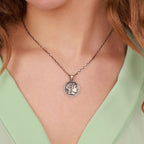 An oxidized Alexander the Great coin necklace worn by women with green
