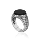 Silver ring with a black stone on a white background