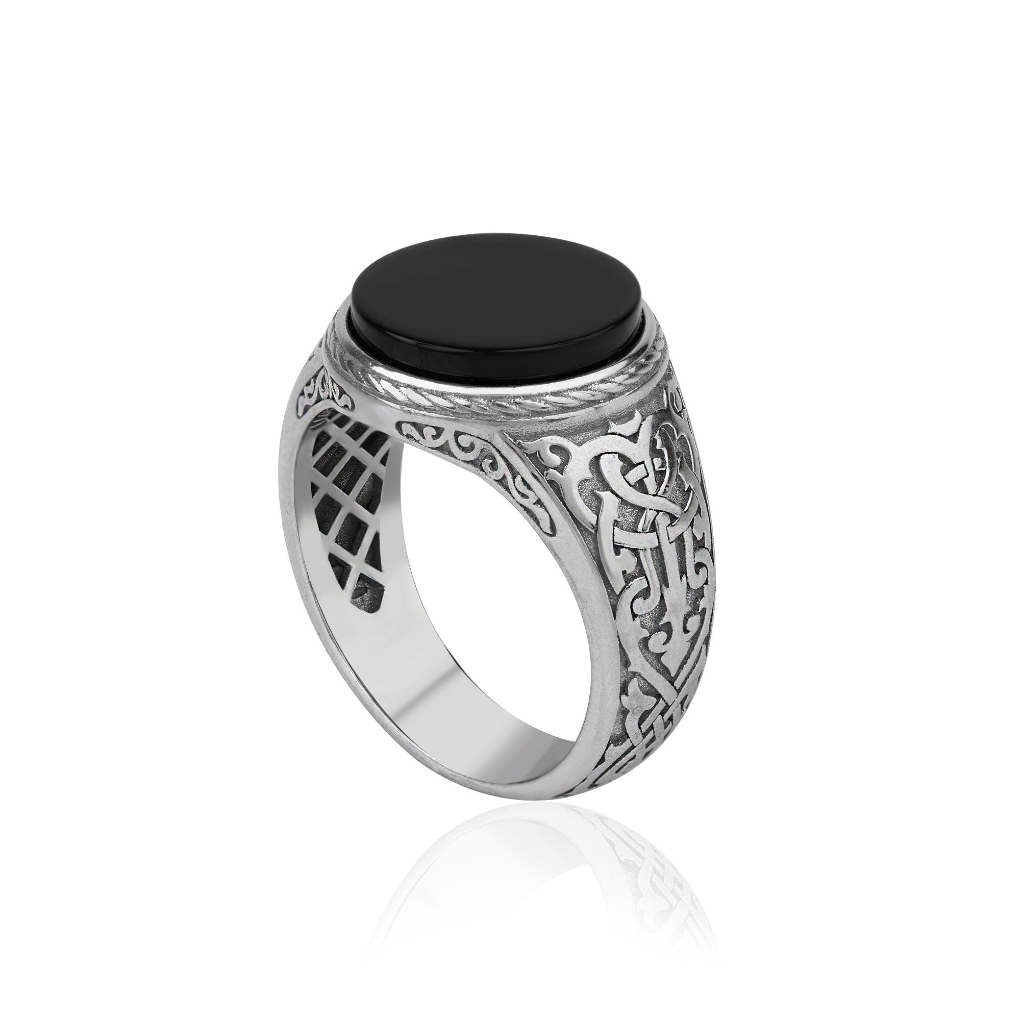 Silver ring with a black stone on a white background