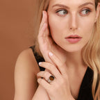 Woman with blonde hair wearing tiger's eye ring