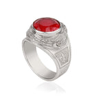 Silver ring with a red gemstone on a white background