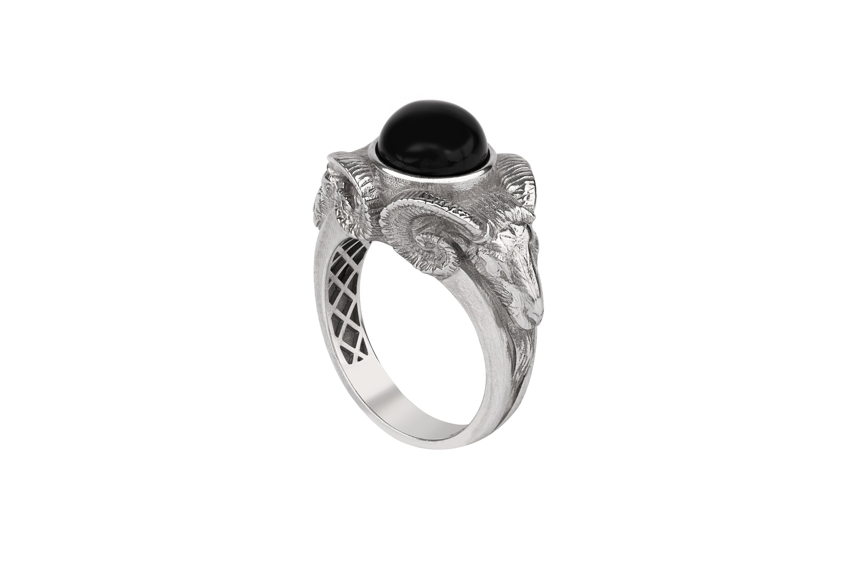 Silver ram ring with a black gemstone on a white background