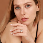 Woman wearing a diamond ring on a brown background
