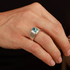 Close-up of hands with rings on a dark background