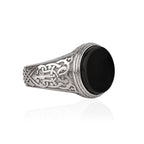 Silver ring with Celtic patterns on a white background
