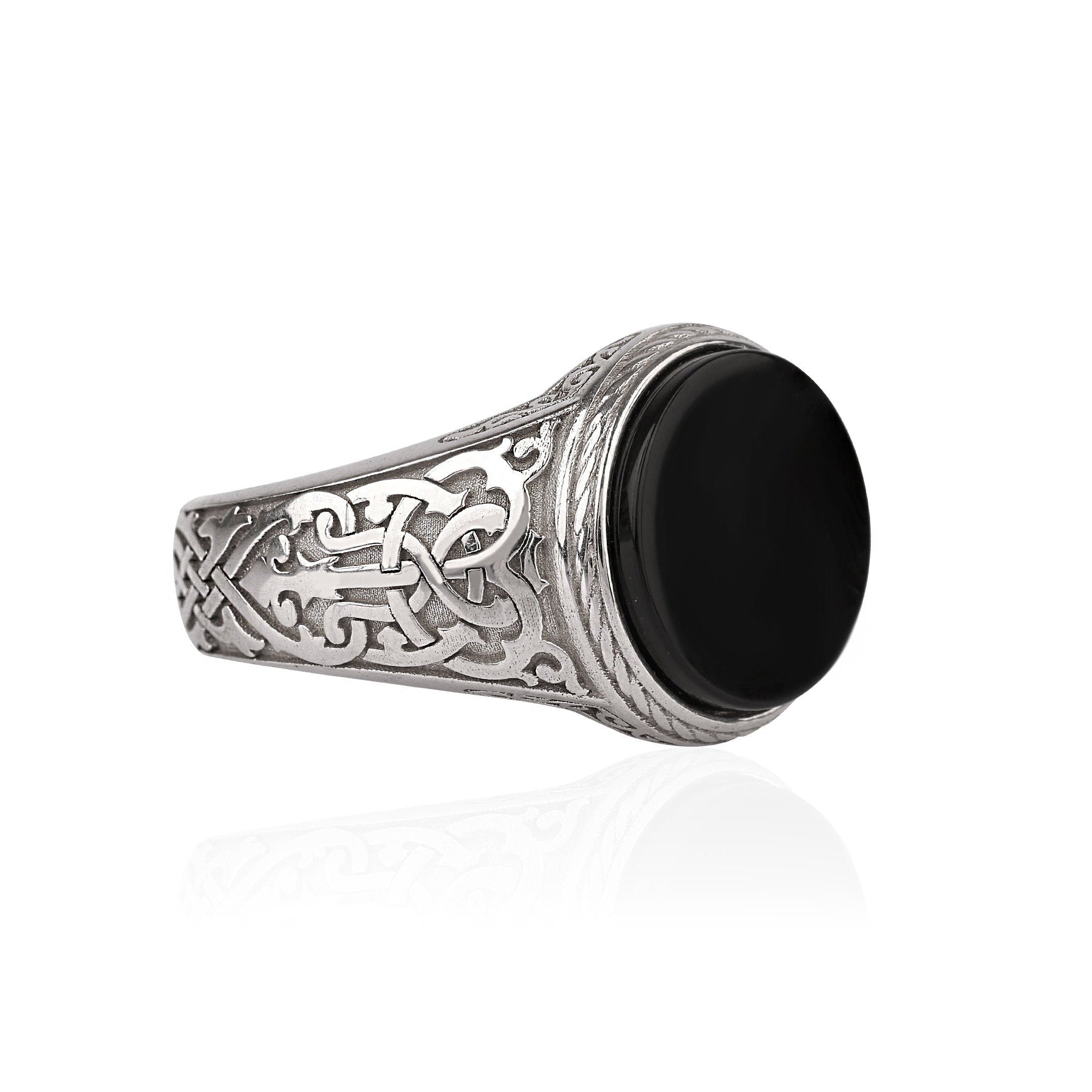 Silver ring with Celtic patterns on a white background