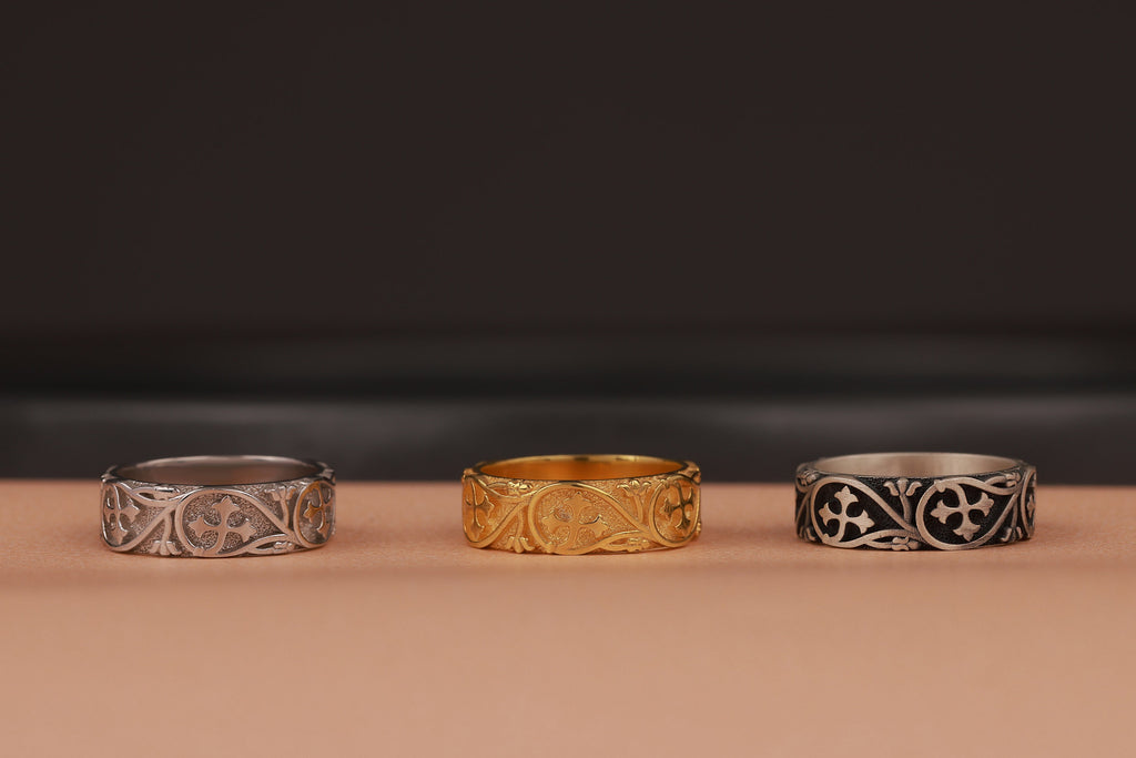 gold, polished and oxidized three-band rings on beige and black background
