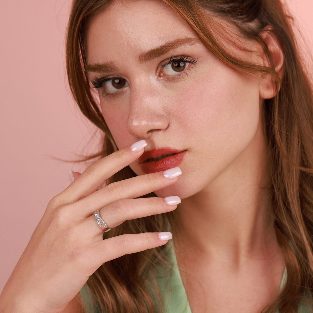 Close-up of a woman with a pink background
