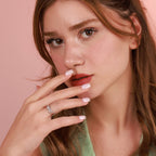 Close-up of a woman with a pink background