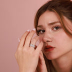 A polished silver band ring worn by a woman