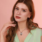 A woman wearing an oxidized necklace with a pink background