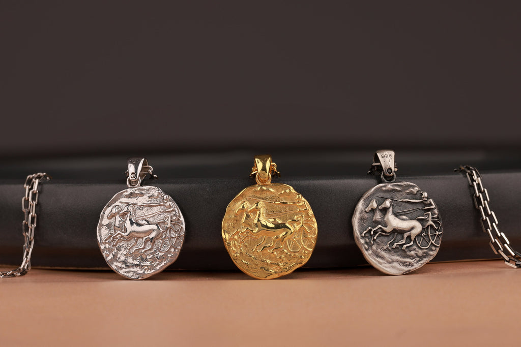 Four pendants on chains against a dark background