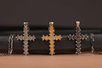 Three five-petal flowers cross pendant, polished silver, gold vermeil and oxidized againt black and beige background