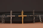 Three different finishes of gothic cross necklaces on a black background