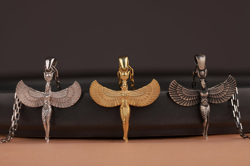 Three Egyptian-style pendants on a dark background