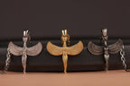 Three Egyptian-style pendants on a dark background