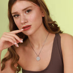 Woman wearing a necklace with a green background