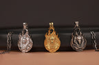 Three anubis-themed pendants on a dark background