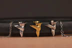 Three sterling silver hummingbird pendants on a black and brown background