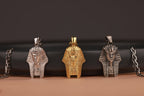 Three Egyptian-themed pendants on a dark background