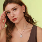 Woman wearing a polished sterling silver horse necklace with a green background