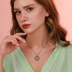 Woman wearing a sterling silver oxidized horse necklace with a pink background