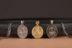 Three religious pendants on a black and brown gradient background