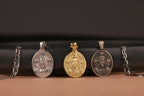 Four Jesus Christ pendants with different materials on a black and brown background