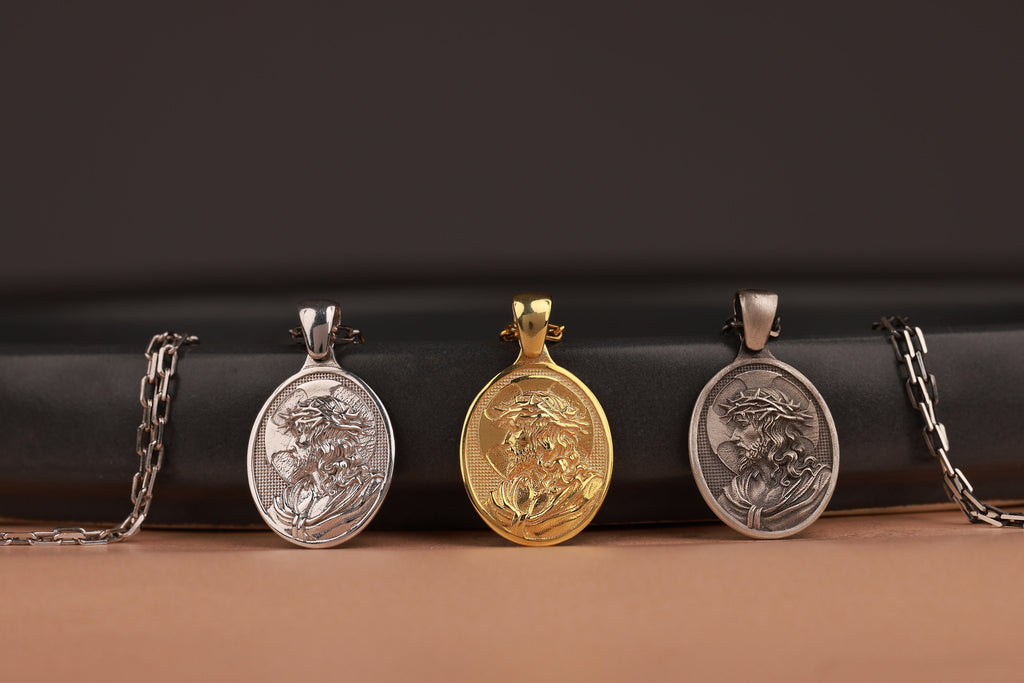 Three Crown of thorn Jesus pendants on a black and brown gradient background