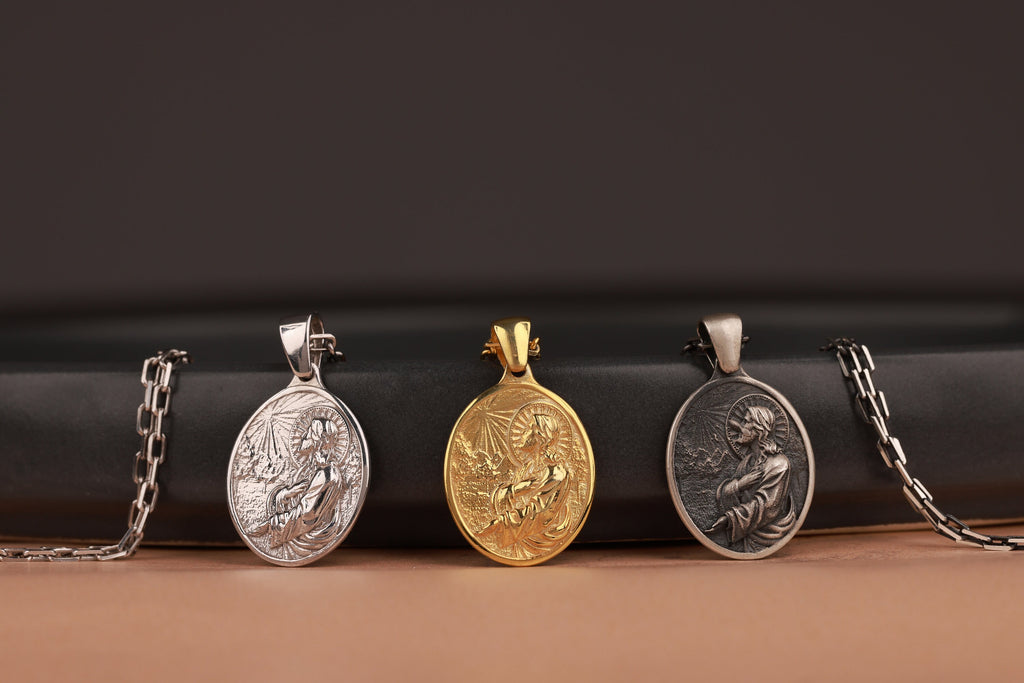 Three jesus in prayer pendant necklaces on a black and brown gradient background