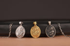 Three jesus in prayer pendant necklaces on a black and brown gradient background