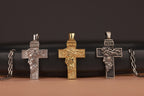 Three inri jesus cross pendants on a dark background