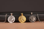 Four different necklaces with pendants on a brown surface and a black background