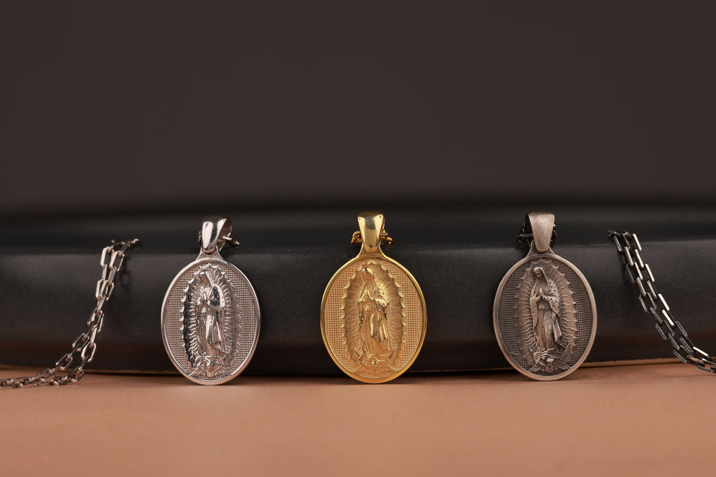 Three religious pendants on a black and brown gradient background