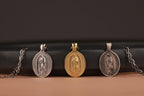 Three religious pendants on a black and brown gradient background