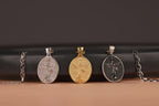 Three St Michael the Archangel pendants on a black and brown gradient background