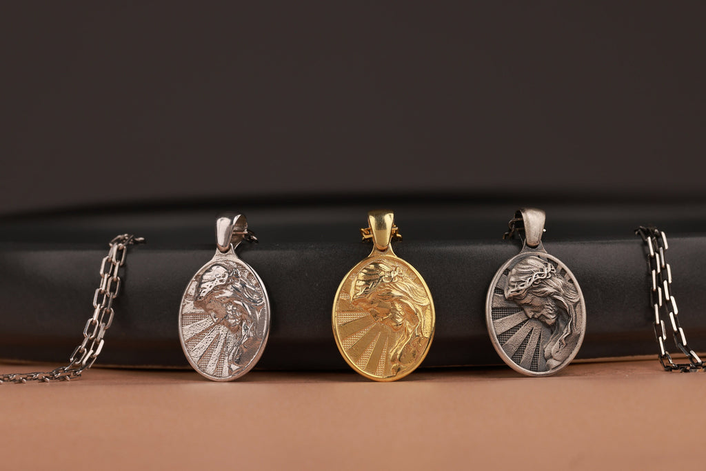 Three oval Jesus pendants on a black and brown gradient background