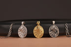 Three oval Jesus pendants on a black and brown gradient background