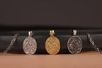Three nativity of jesus pendants on chains against a dark background