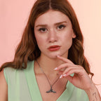Woman wearing an oxidized necklace with a pink background