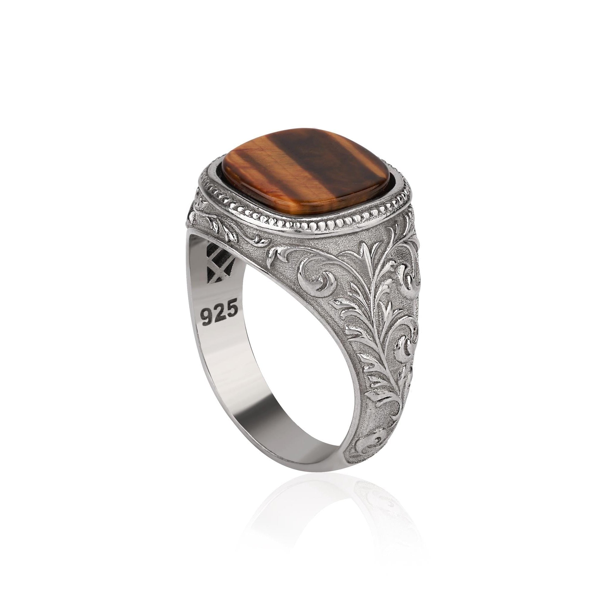 Silver ring with a cushion cut tiger's eye on a white background