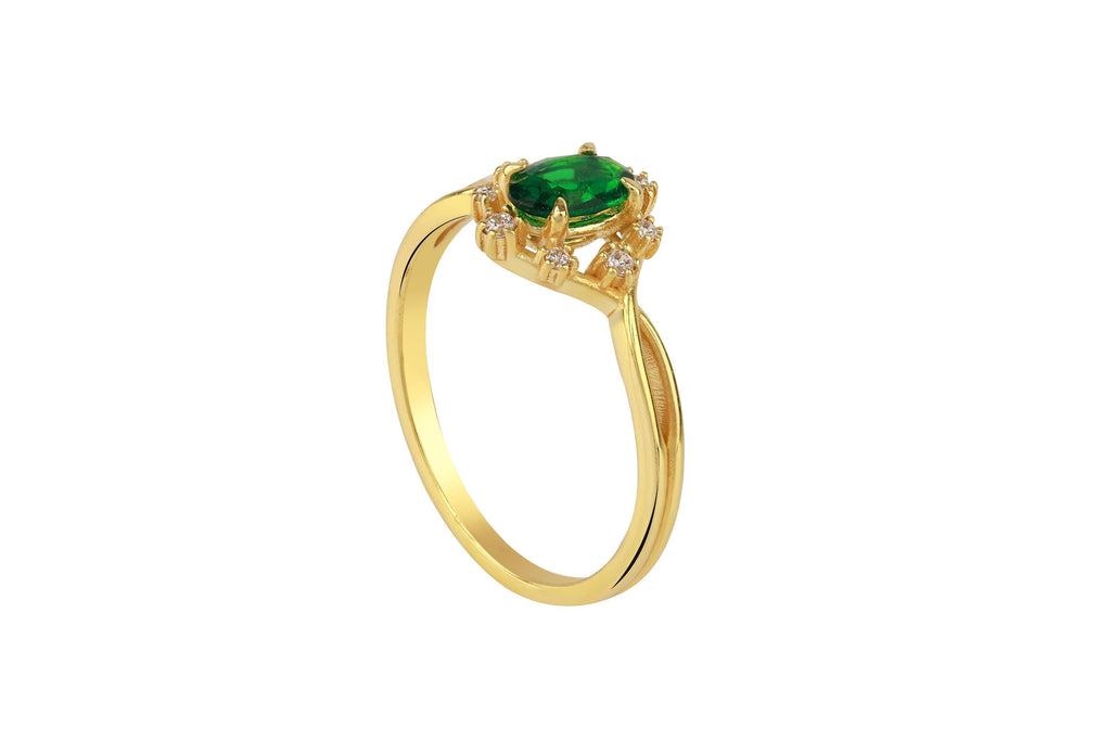Gold ring with a green gemstone on a white background