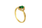 Gold ring with a green gemstone on a white background