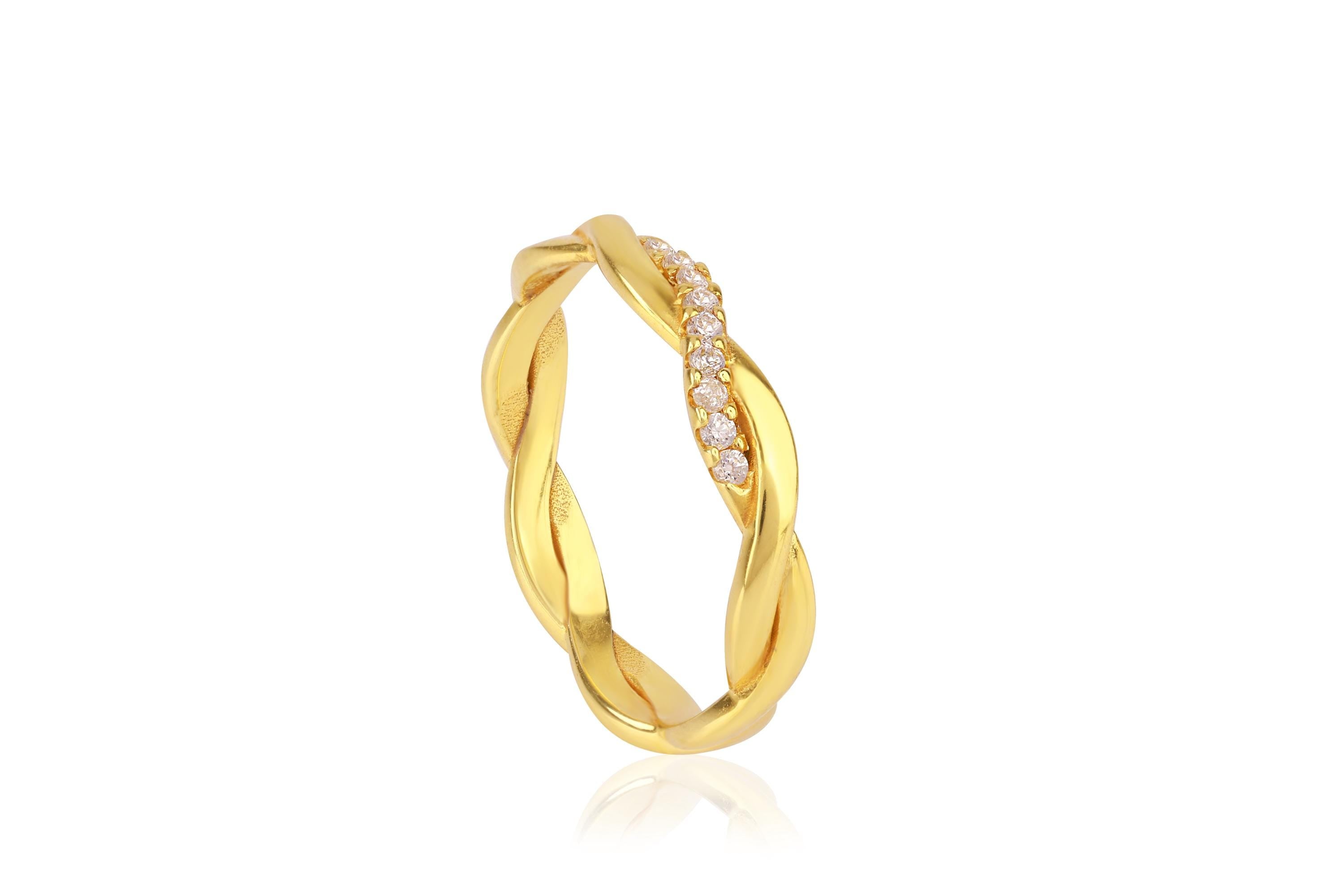 Gold ring with diamond accents on a white background