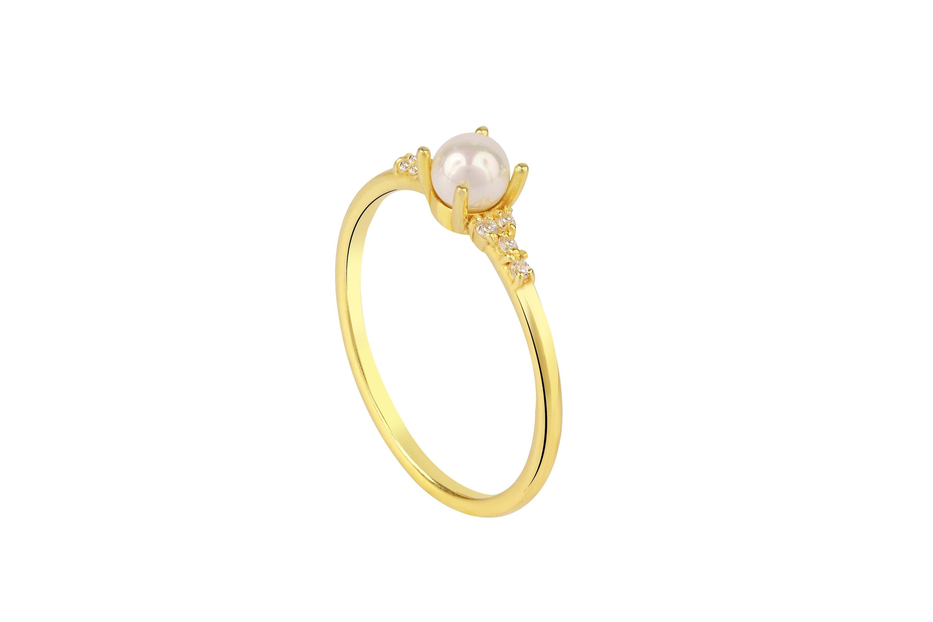 Gold ring with a pearl on a white background