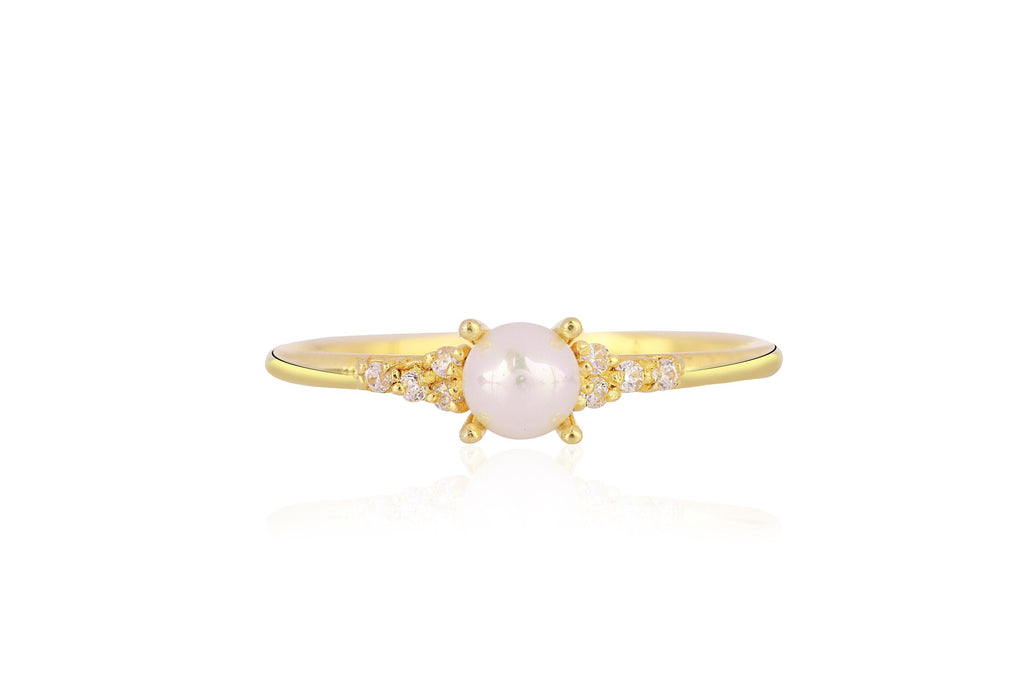 Gold ring with a pearl and small diamonds on a white background