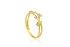Gold ring with a leaf design on a white background