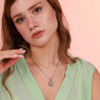 Woman wearing an Our Lady of Guadalupe necklace with a pendant against a pink background