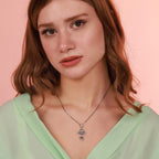 Woman wearing a sterling silver cross necklace with the "Only God Can Judge Me" phrase