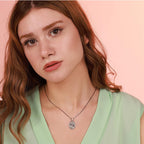 Woman wearing a jesus necklace with a pink background